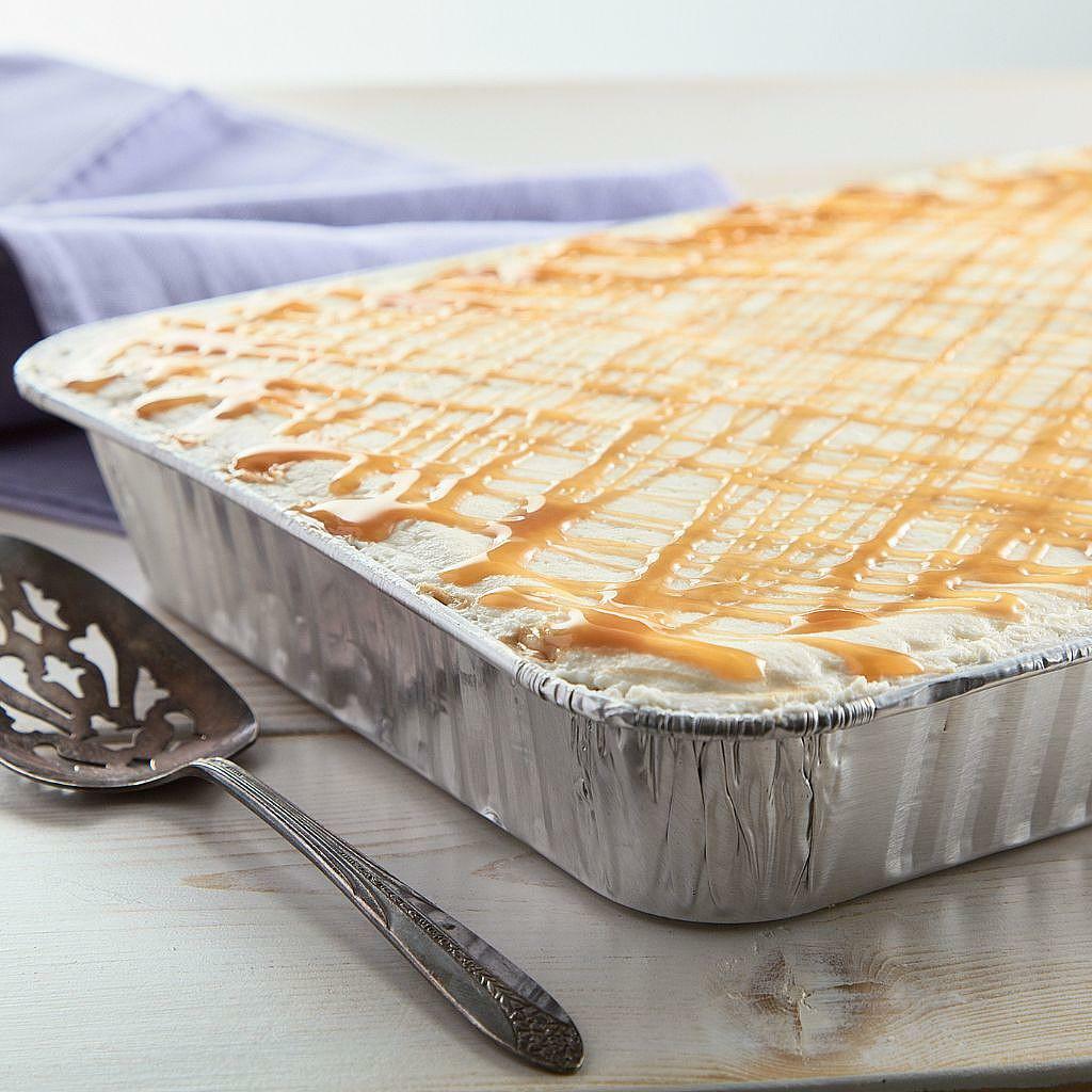 Sheet cake with white frosting and caramel drizzle