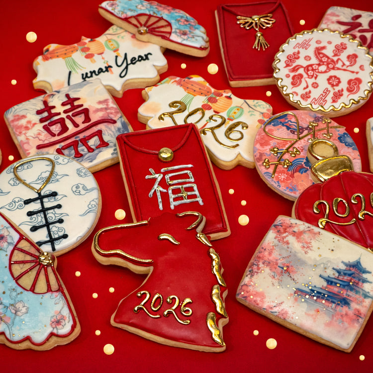 Assorted Lunar New Year cookies with festive red and gold icing.