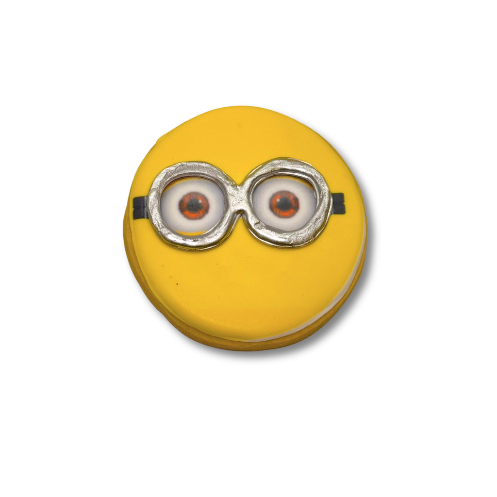 Minions cookie with yellow icing and silver goggles.