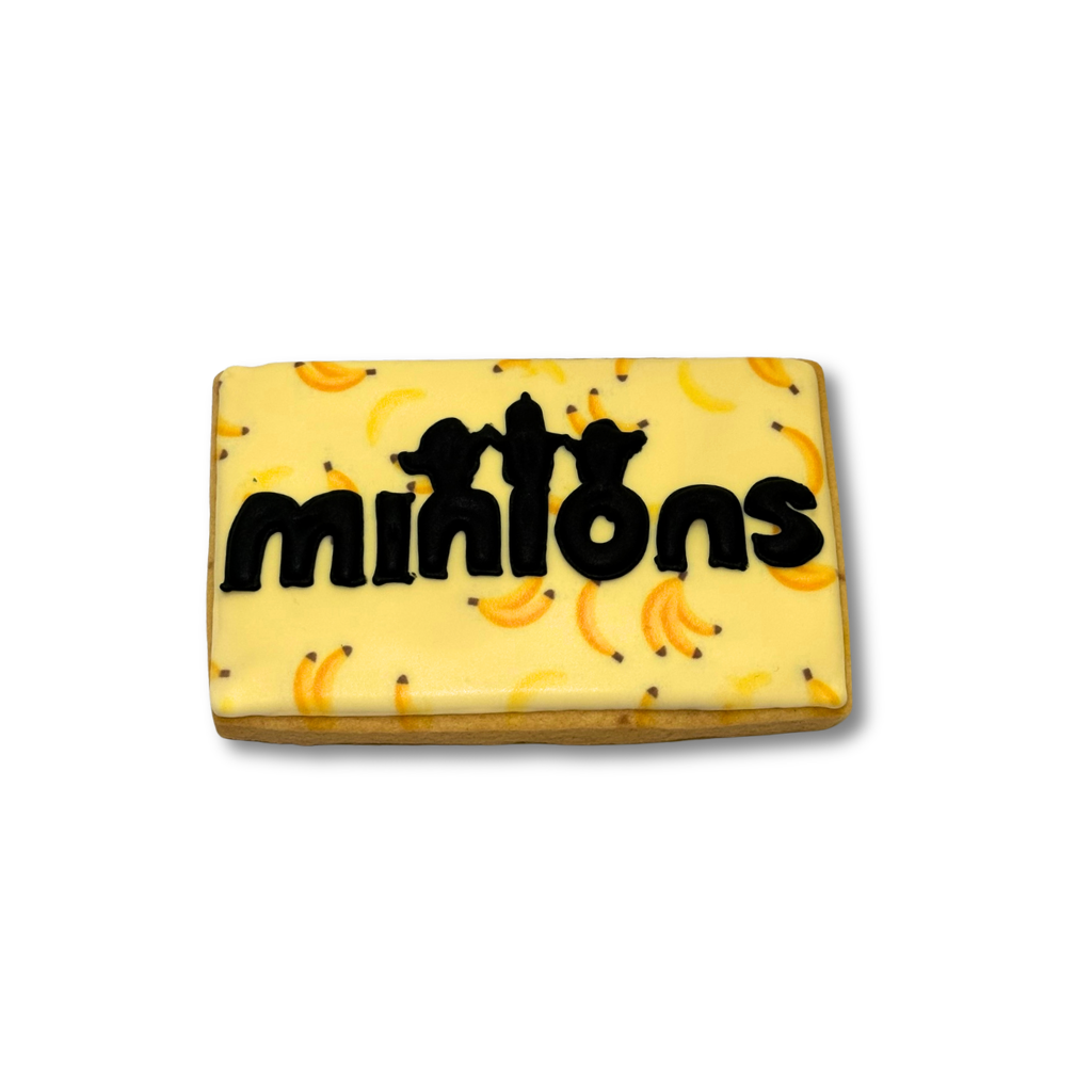 Minions cookie with yellow banana icing and black lettering.