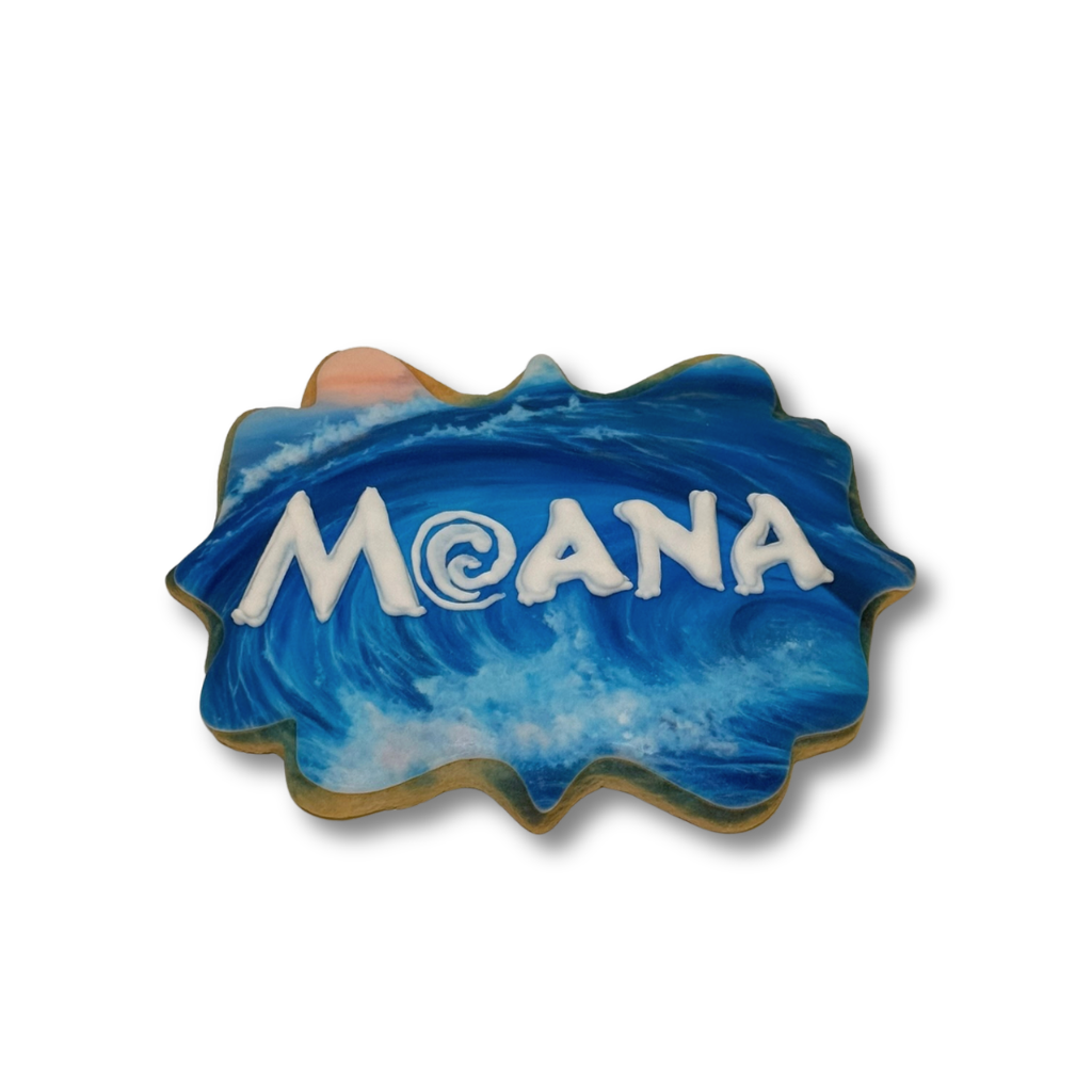 Moana cookie with blue ocean wave icing and white lettering.