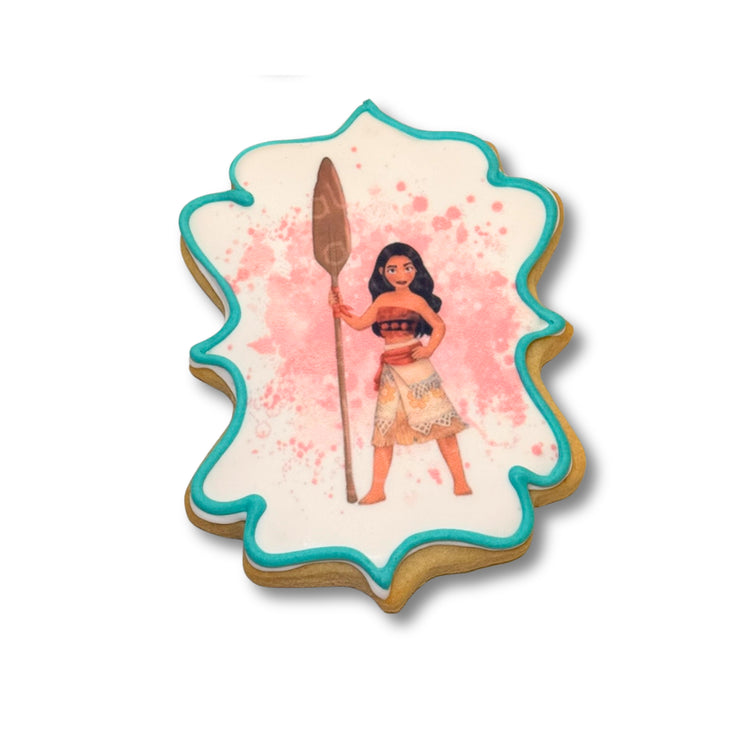 Moana cookie with teal icing and pink splatter design.