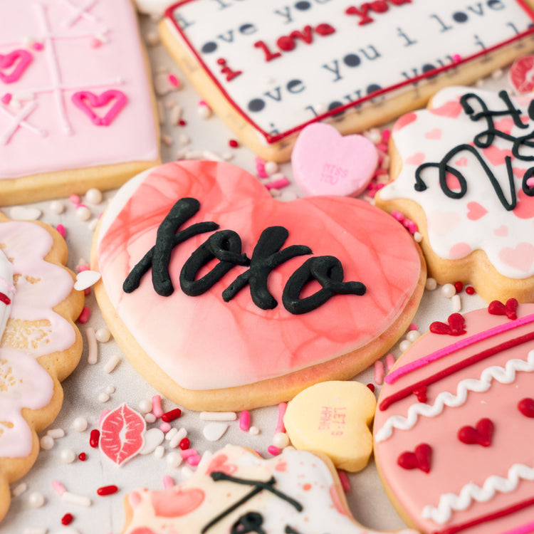 Assorted Valentine butter cookies decorated with pink icing.