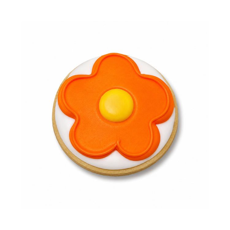 Lizzie McGuire cookie with orange and yellow flower icing.