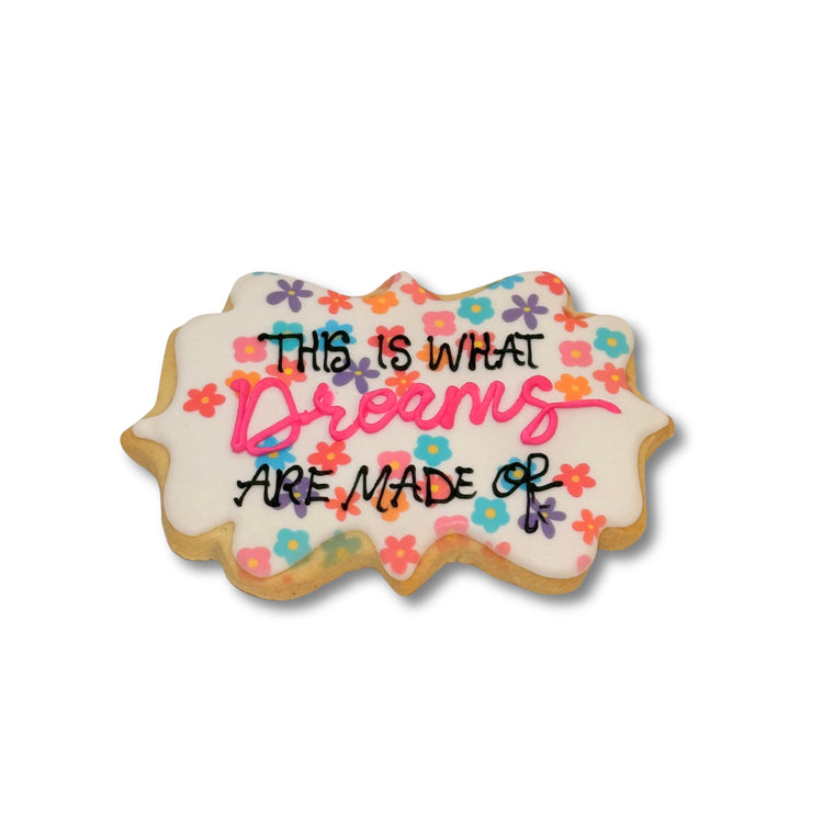 Lizzie McGuire cookie with floral icing and quote text.