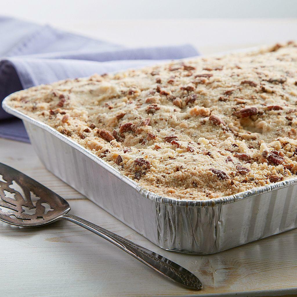 Apple Brown Betty in a 13x9 aluminum pan with a serving spoon.