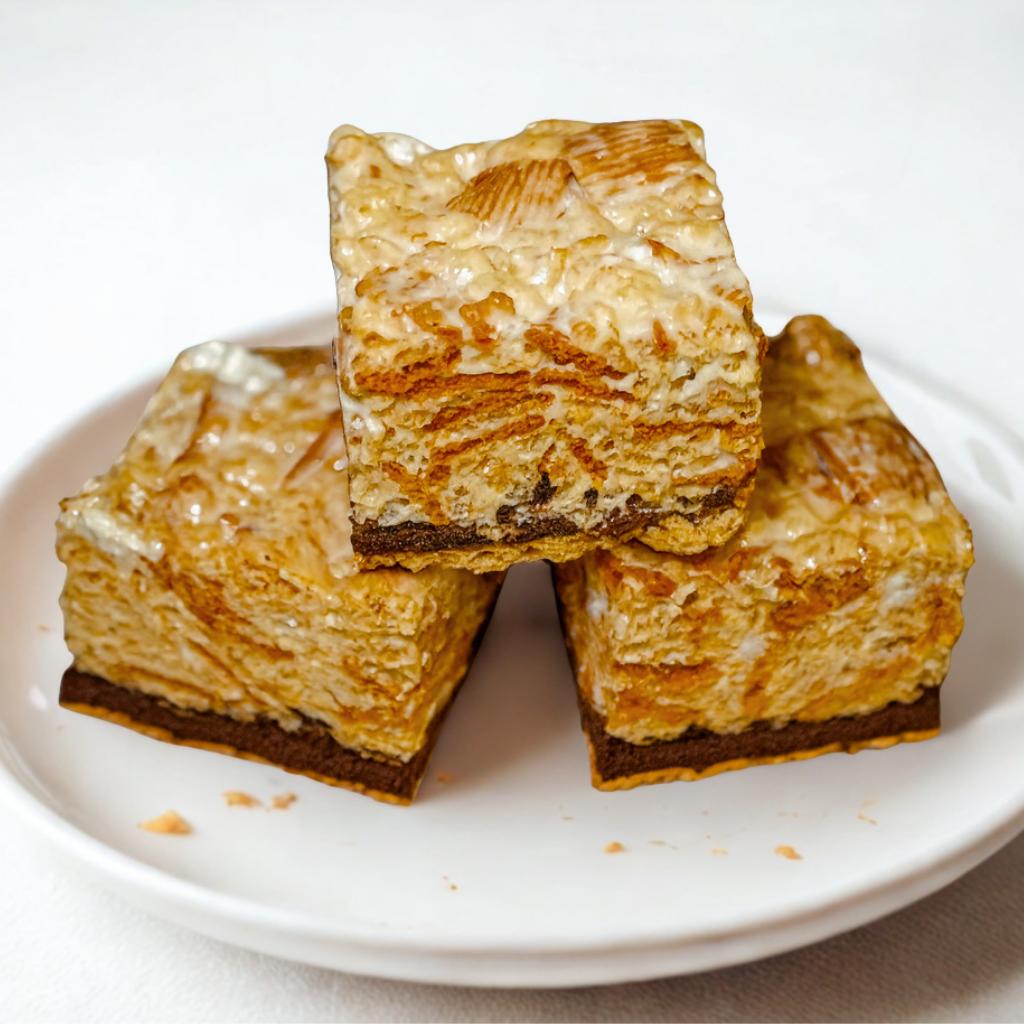 S’mores Rice Krispie Treats stacked on a white plate.