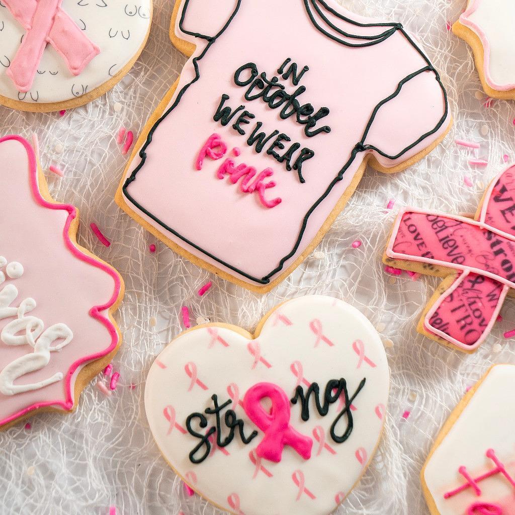 Assorted Breast Cancer Awareness cookies with pink icing.