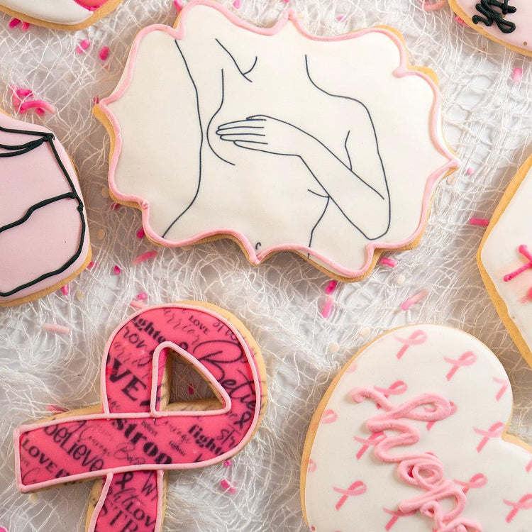 Assorted Breast Cancer Awareness cookies with pink icing.