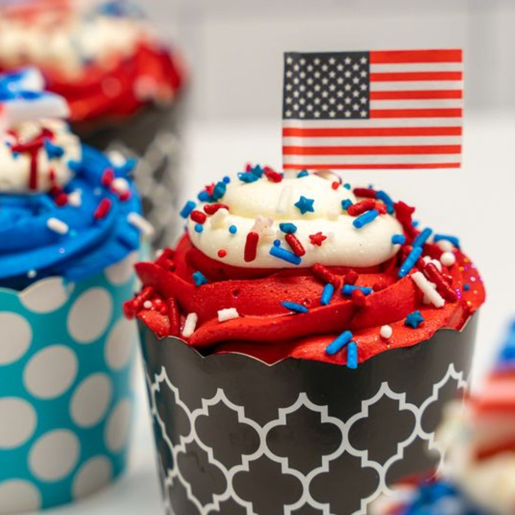 4th of July cupcakes with American flag toppers and sprinkles