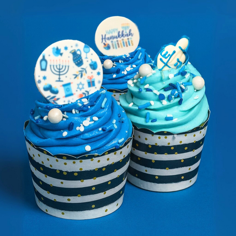 Hanukkah cupcakes with blue frosting and festive toppers.