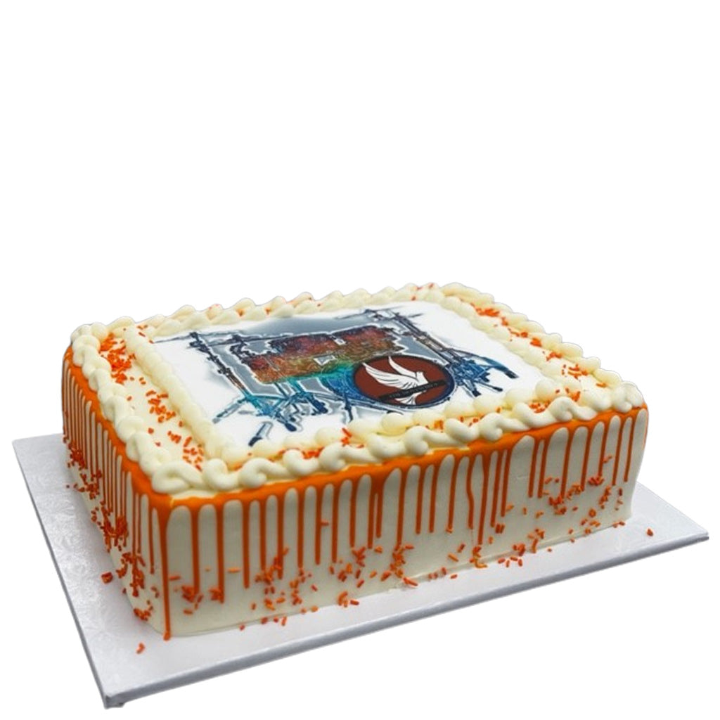 Carrot sheet cake with orange drip icing and edible image.