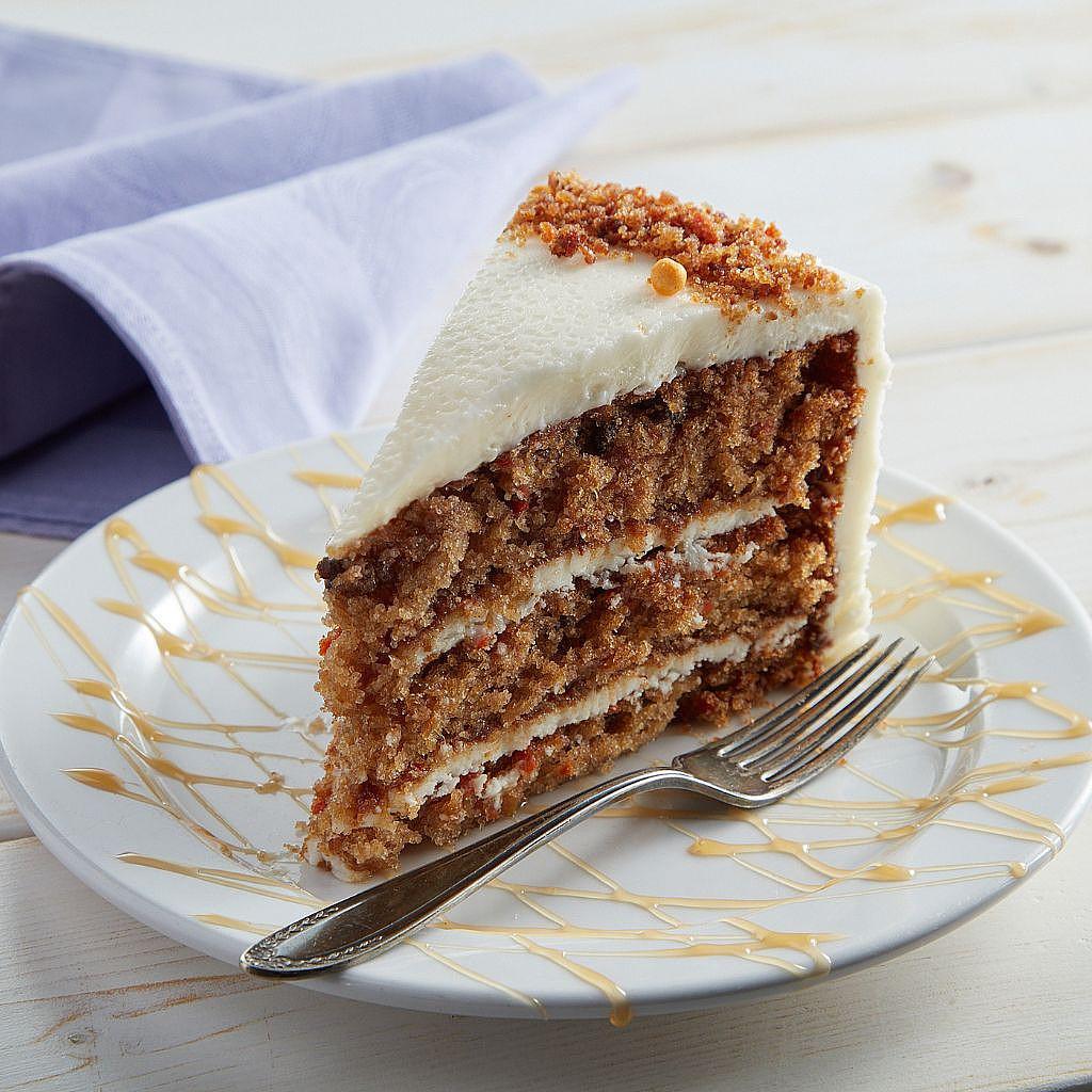 9-inch carrot cake slice with cream cheese frosting on a plate