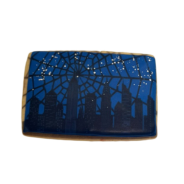 Spiderman cookie with a blue city skyline and web design.