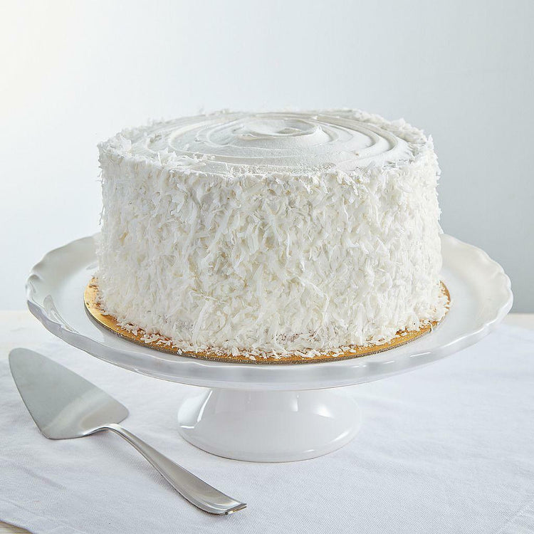 9-inch coconut cream cake covered in shredded coconut flakes