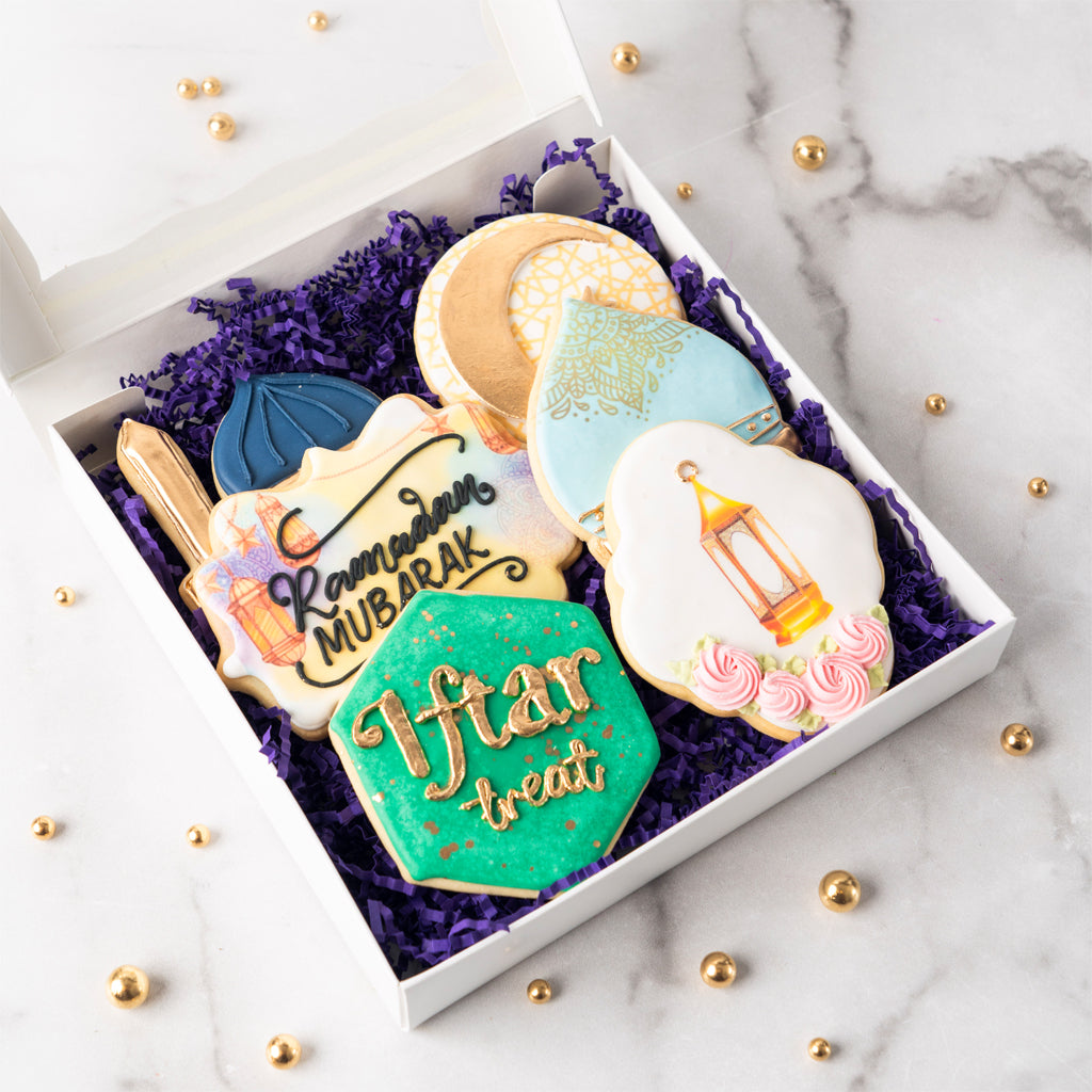Curated gift box of 6 Ramadan cookies on purple paper filler.