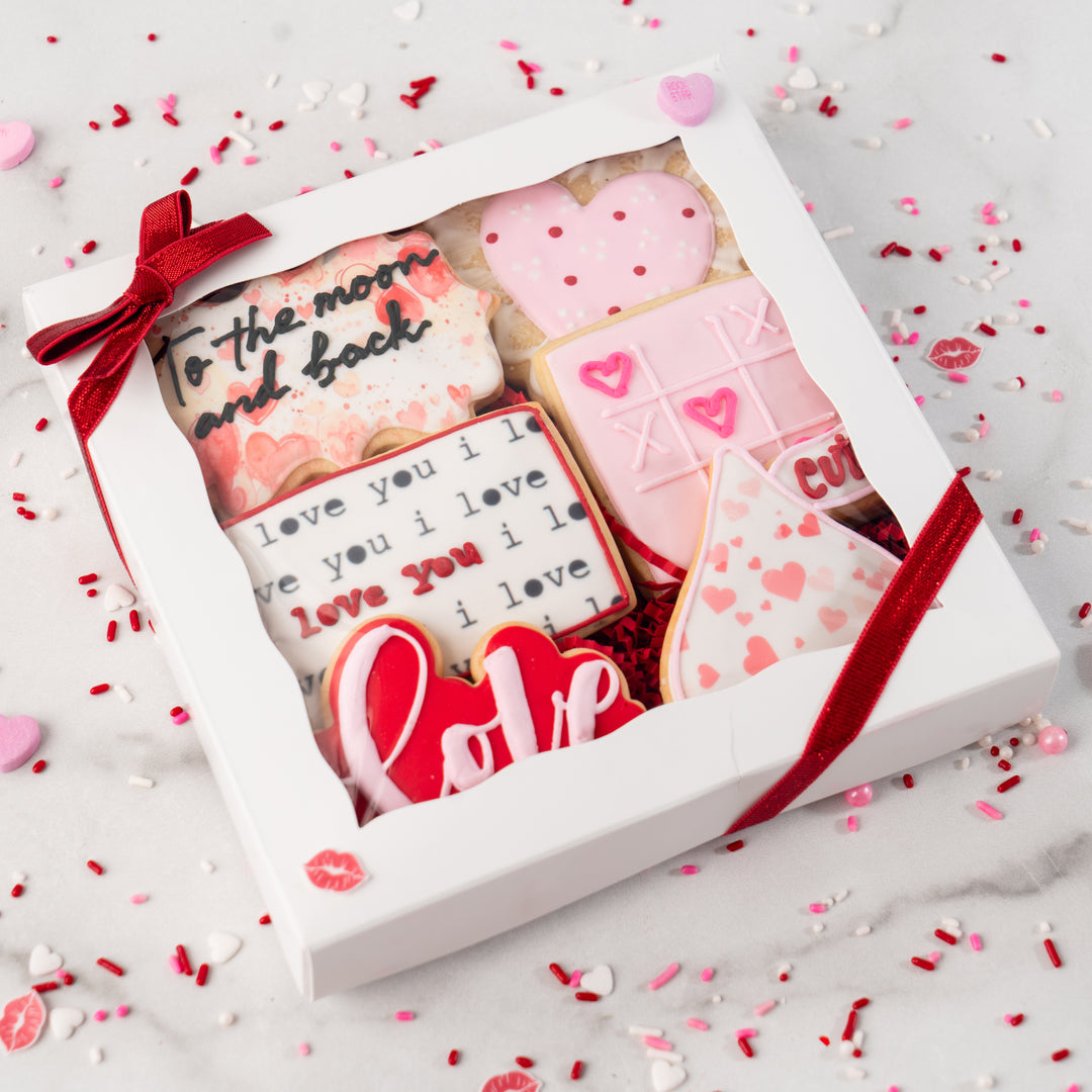 Curated gift box of 6 Valentine cookies with red ribbon.
