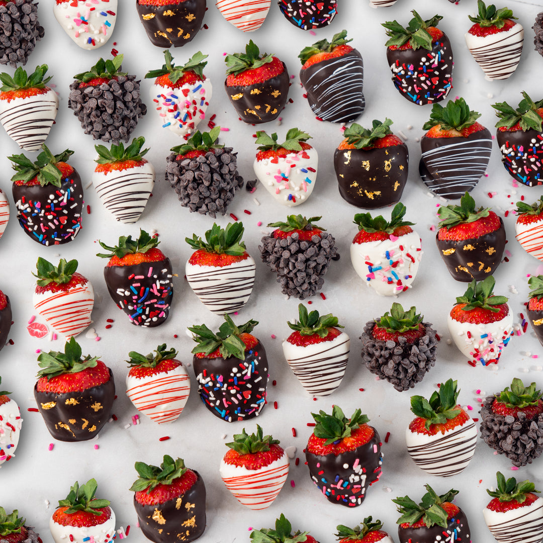 Six chocolate-dipped strawberries with various toppings.