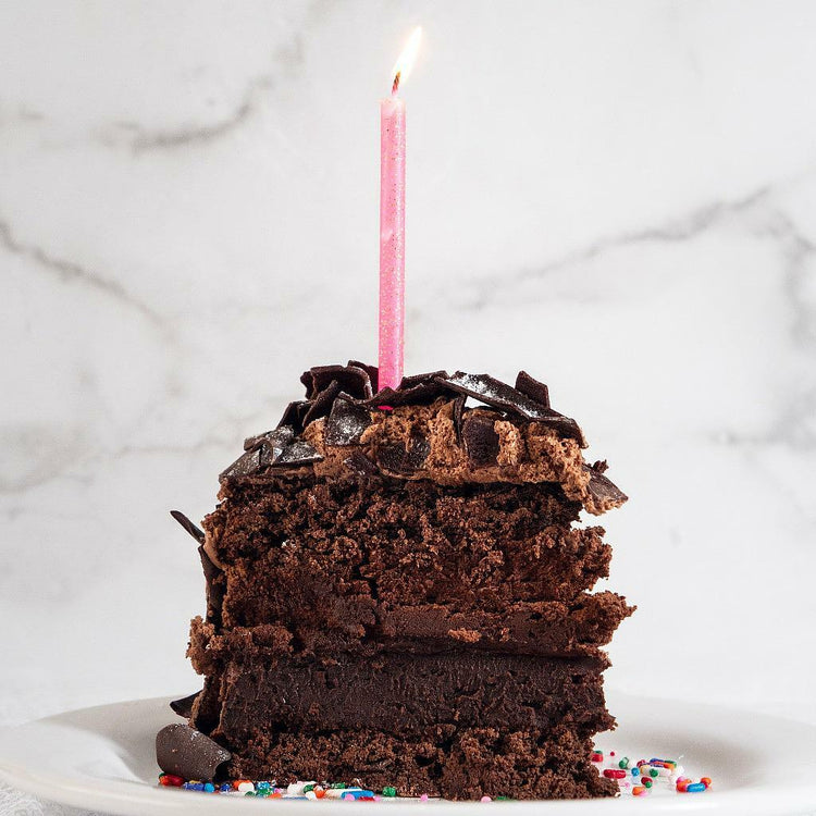 Cosmic Birthday Cake, 9-inch, with a lit pink candle.