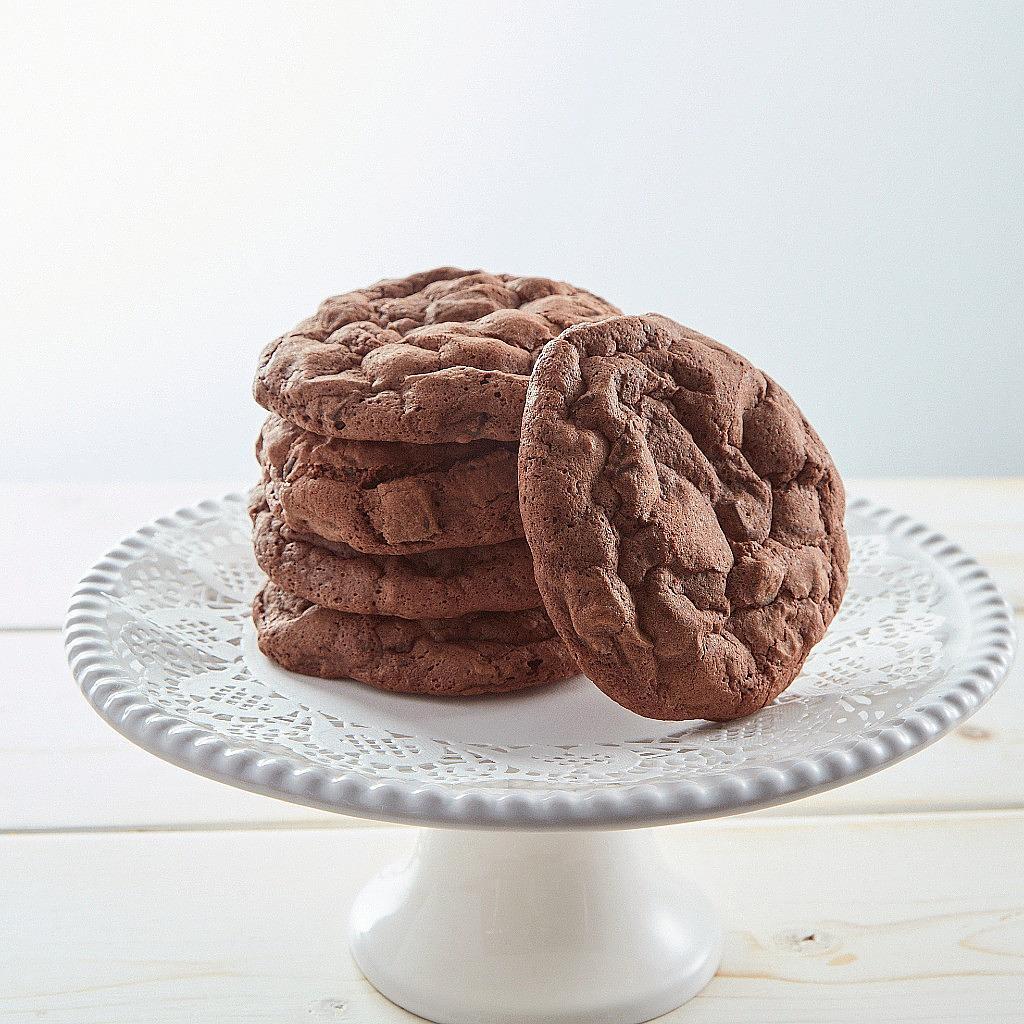 Stack of chocolate brookies on a white pedestal stand