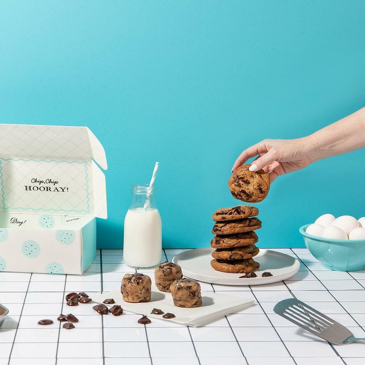 Chocolate Chunk Dough by DG with a stack of baked cookies