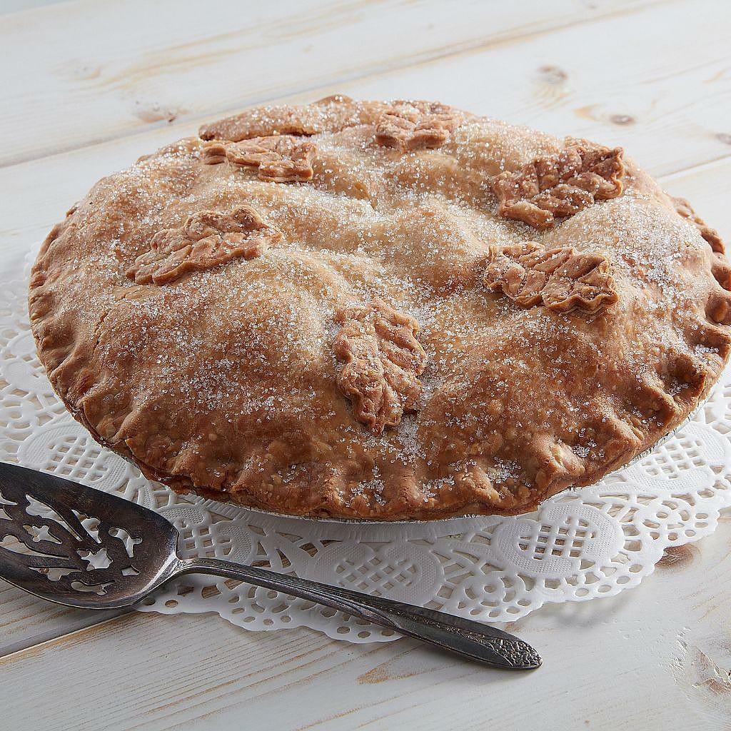 Double crust apple pie with leaf-shaped crust decorations.
