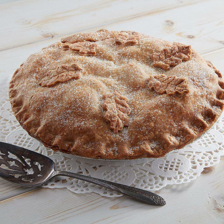 Double crust apple pie with leaf-shaped crust decorations.