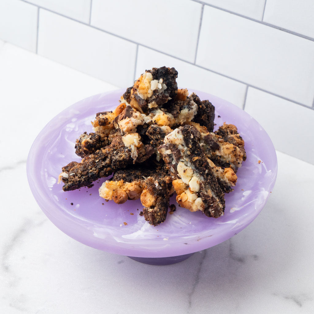 Edges cookie pieces on a purple pedestal stand