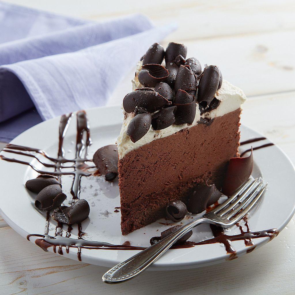 Slice of chocolate mousse cake topped with chocolate curls