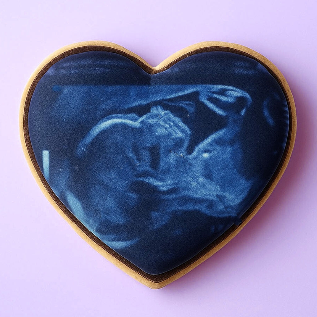 Heart-shaped cookie with a blue ultrasound image print