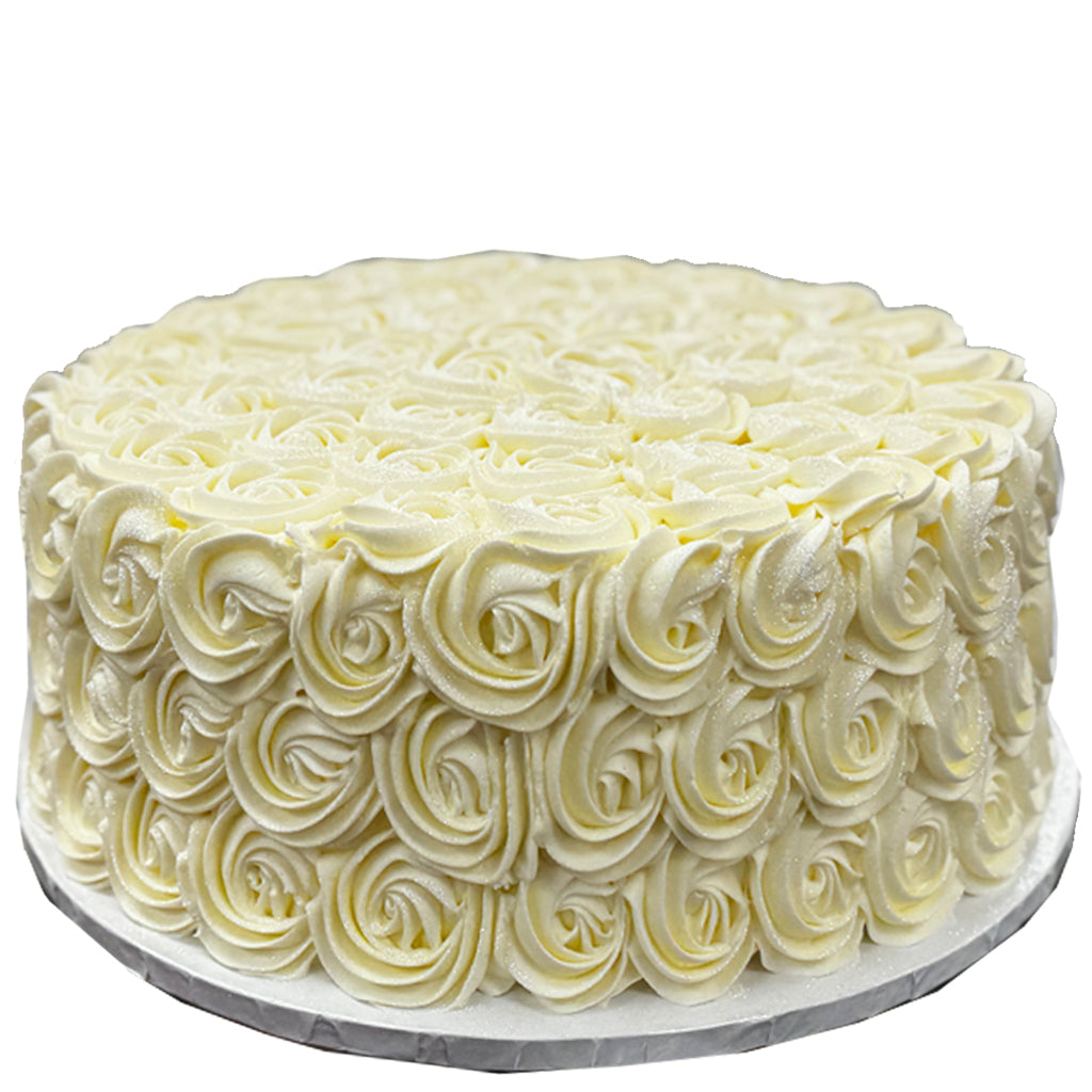 French vanilla cake with white piped buttercream rosettes.