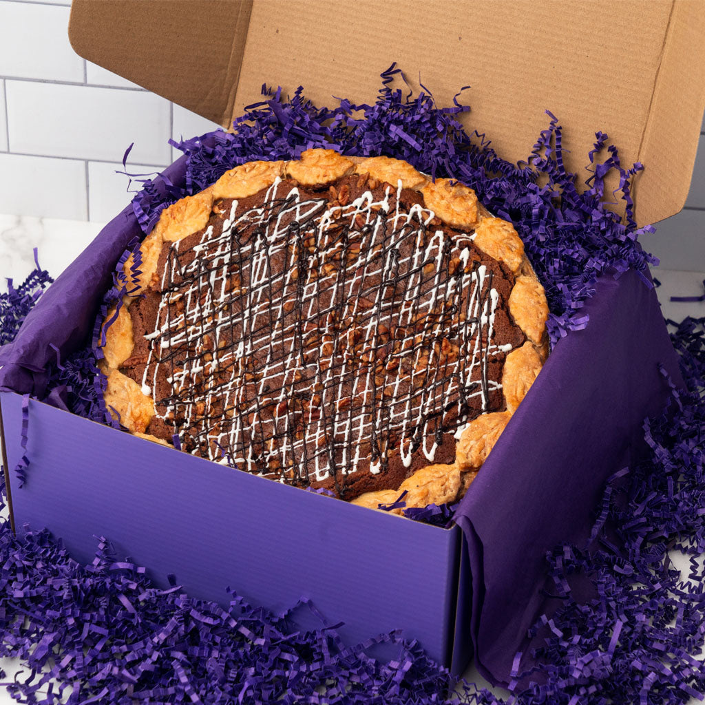 Pie gift box with a chocolate drizzle pie in purple filler.