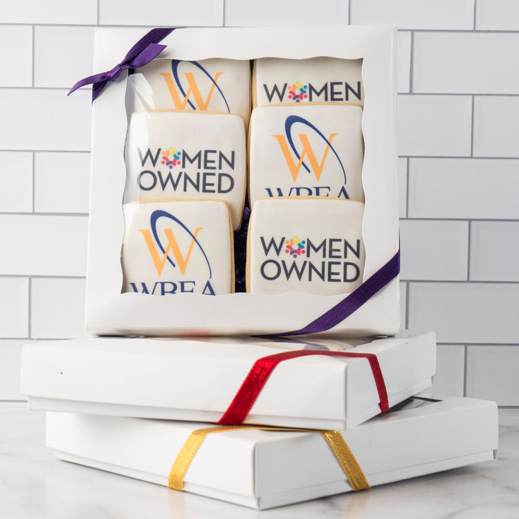 6-pack logo cookies in a white gift box with purple ribbon.