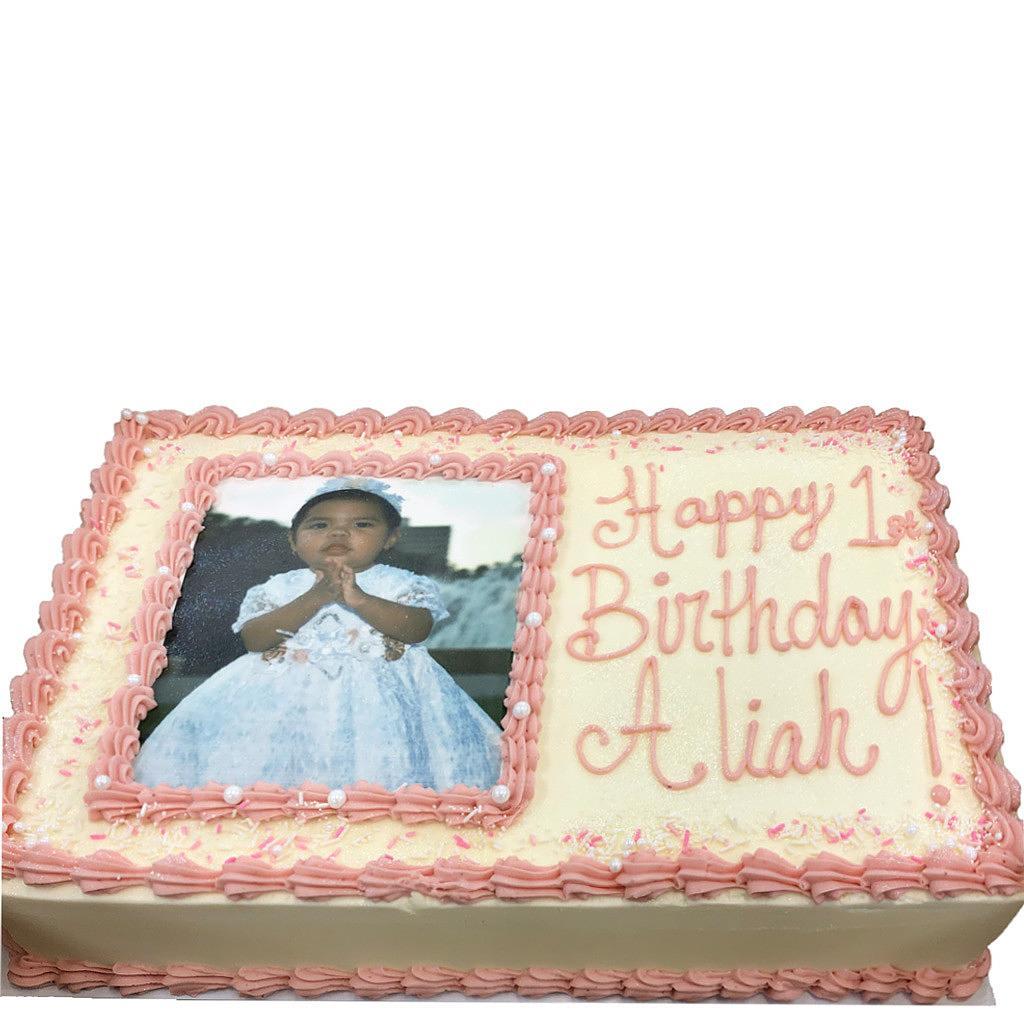 Photo and logo sheet cake with pink frosting and baby photo.