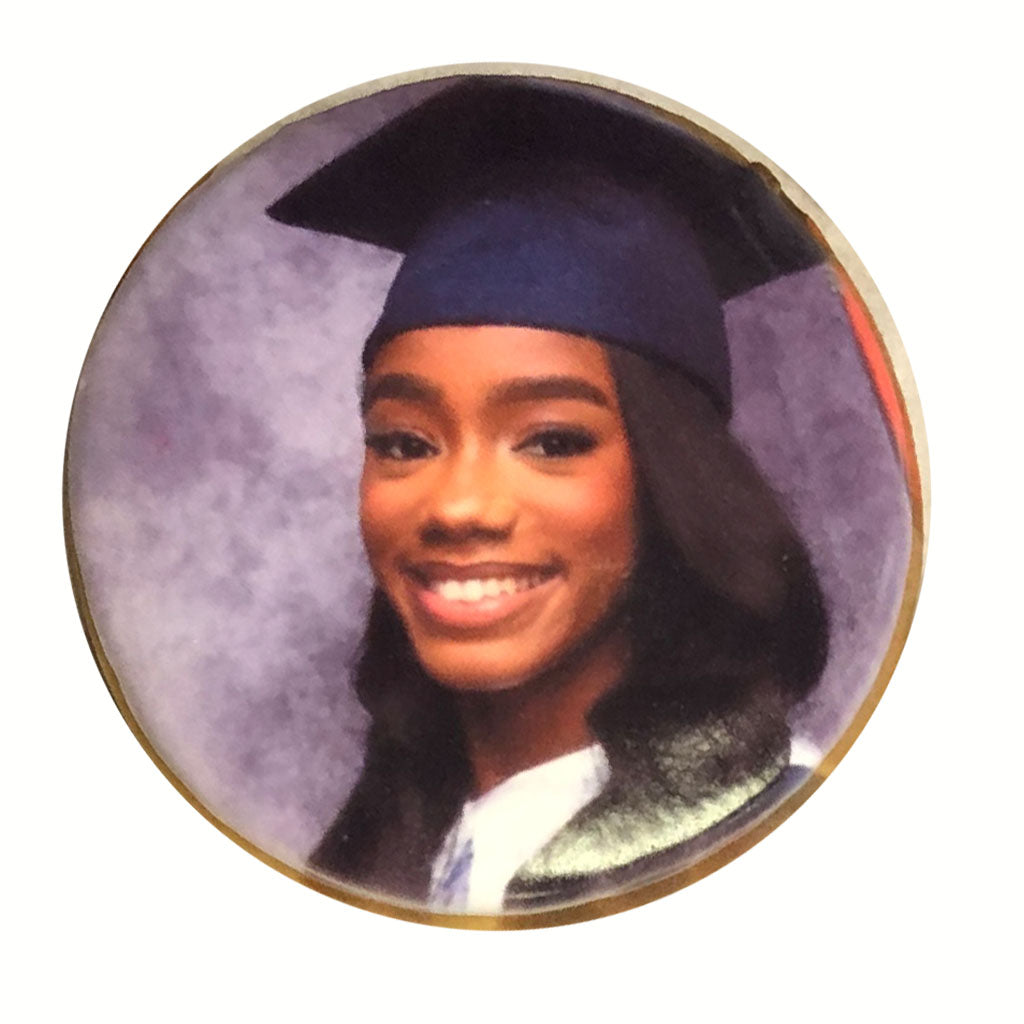 Round cookie featuring a graduate in a cap and gown.