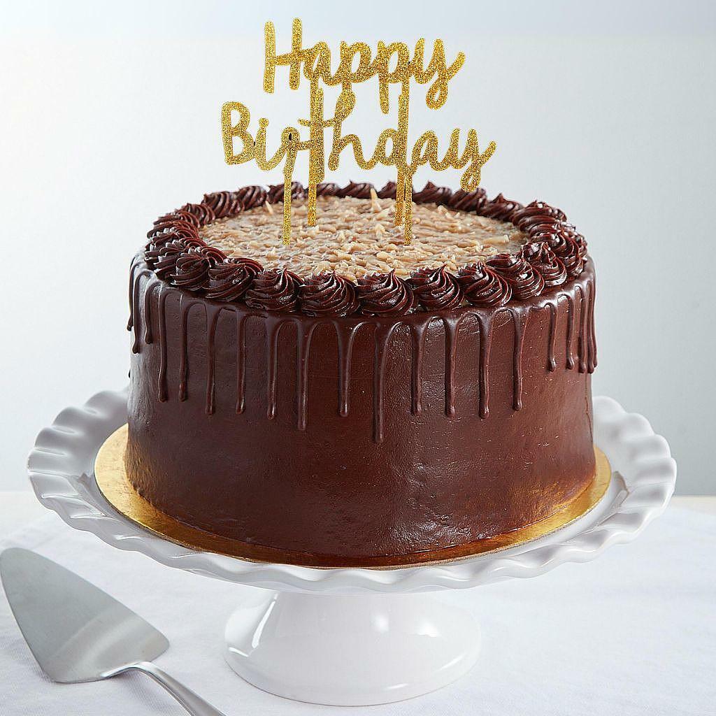 9-inch German chocolate cake with a gold Happy Birthday topper.