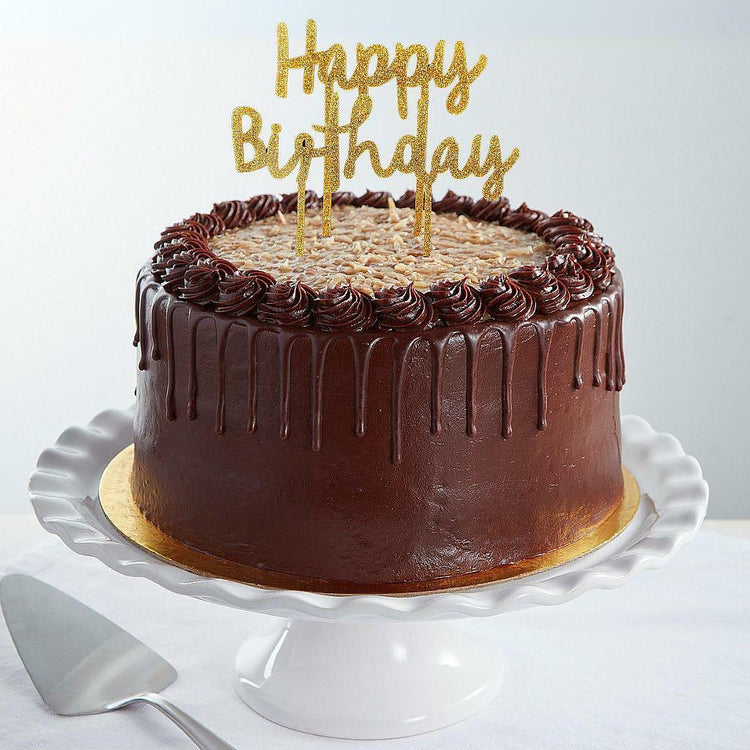 9-inch German chocolate cake with a gold Happy Birthday topper.