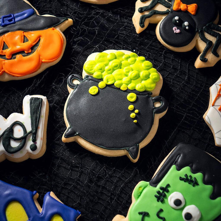 Assorted Halloween cookies featuring a black cauldron design.
