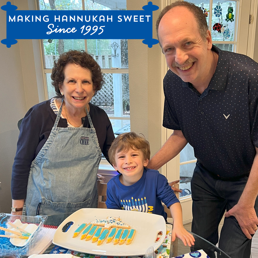 Menorah cookie decorating kit with family at a table.