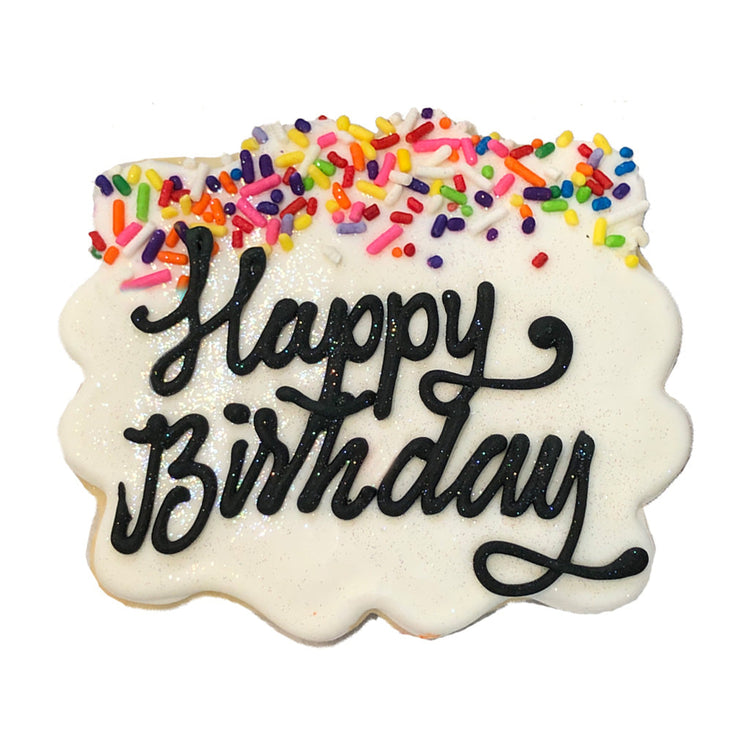 Birthday plaque cookie with white icing and rainbow sprinkles.