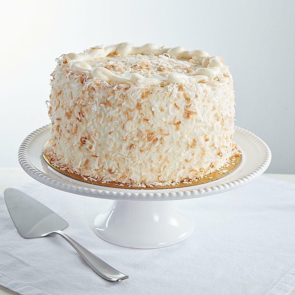 9-inch Italian cream cake topped with toasted coconut flakes.