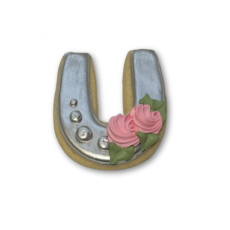 Kentucky Derby horseshoe cookie with silver icing and pink roses