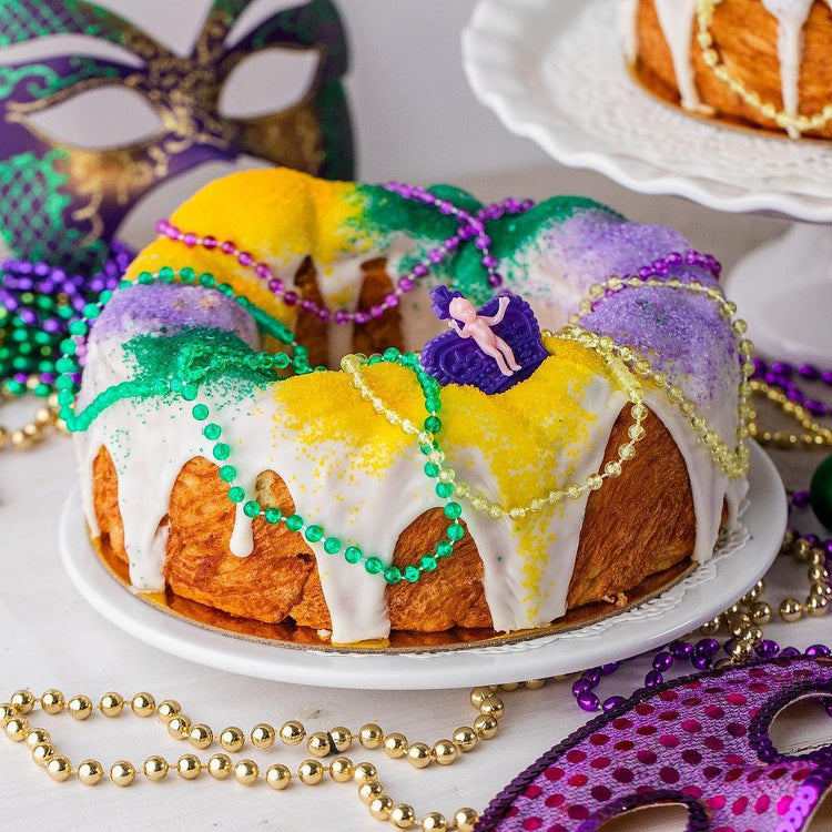 8-inch Cinnamon Swirl King Cake with Mardi Gras beads.