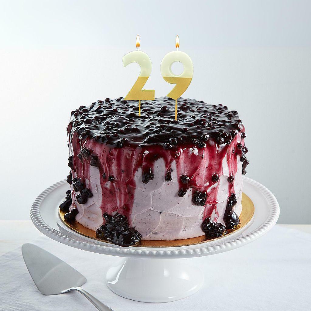 9-inch lemon blueberry cake with gold number 29 candles