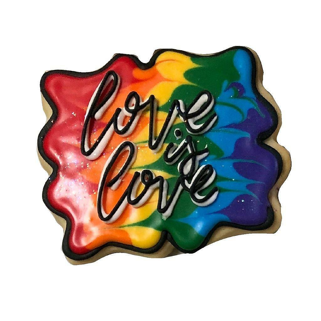 Love is Love cookie with a colorful rainbow marbled icing design.