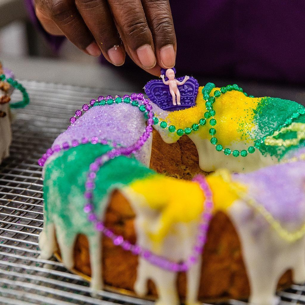 Mardi Gras 2025 king cake with purple, green, and gold sugar.