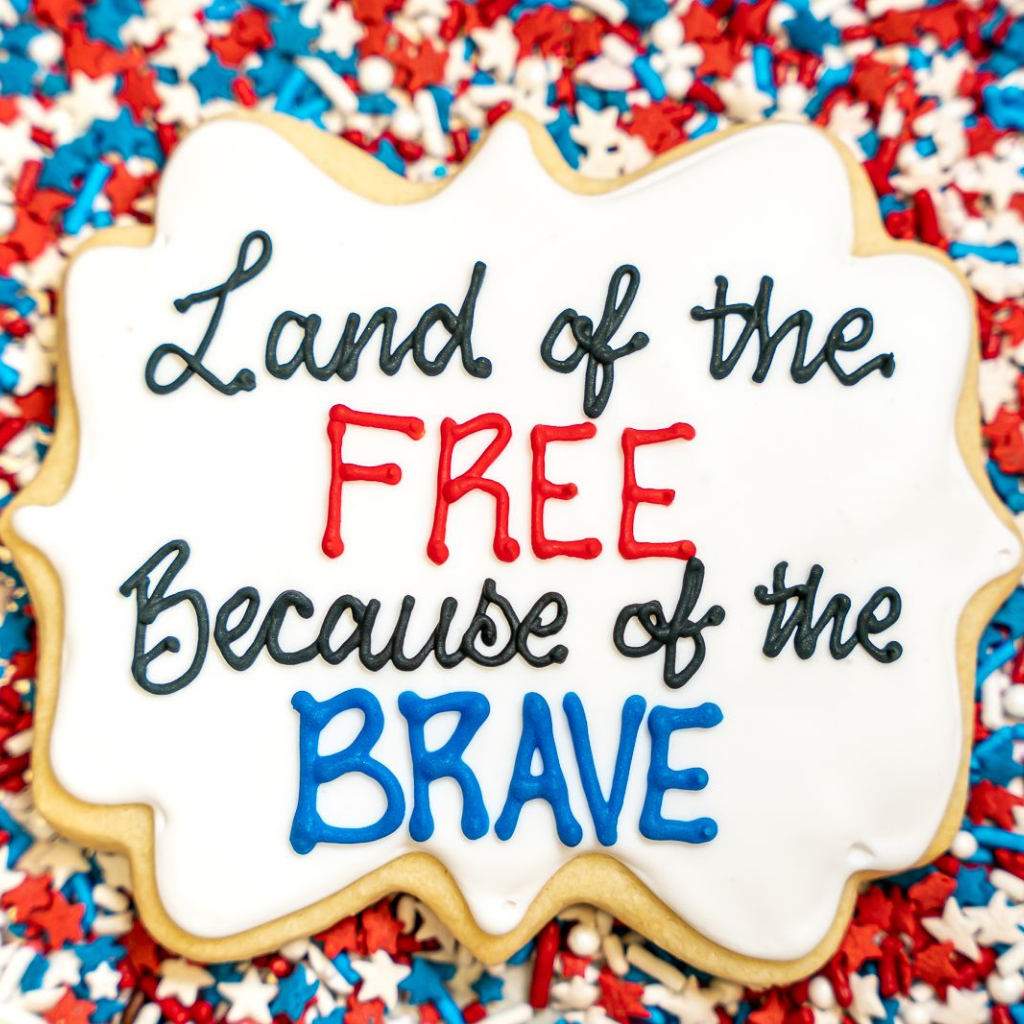 Memorial Day cookie with red, white, and blue icing text.