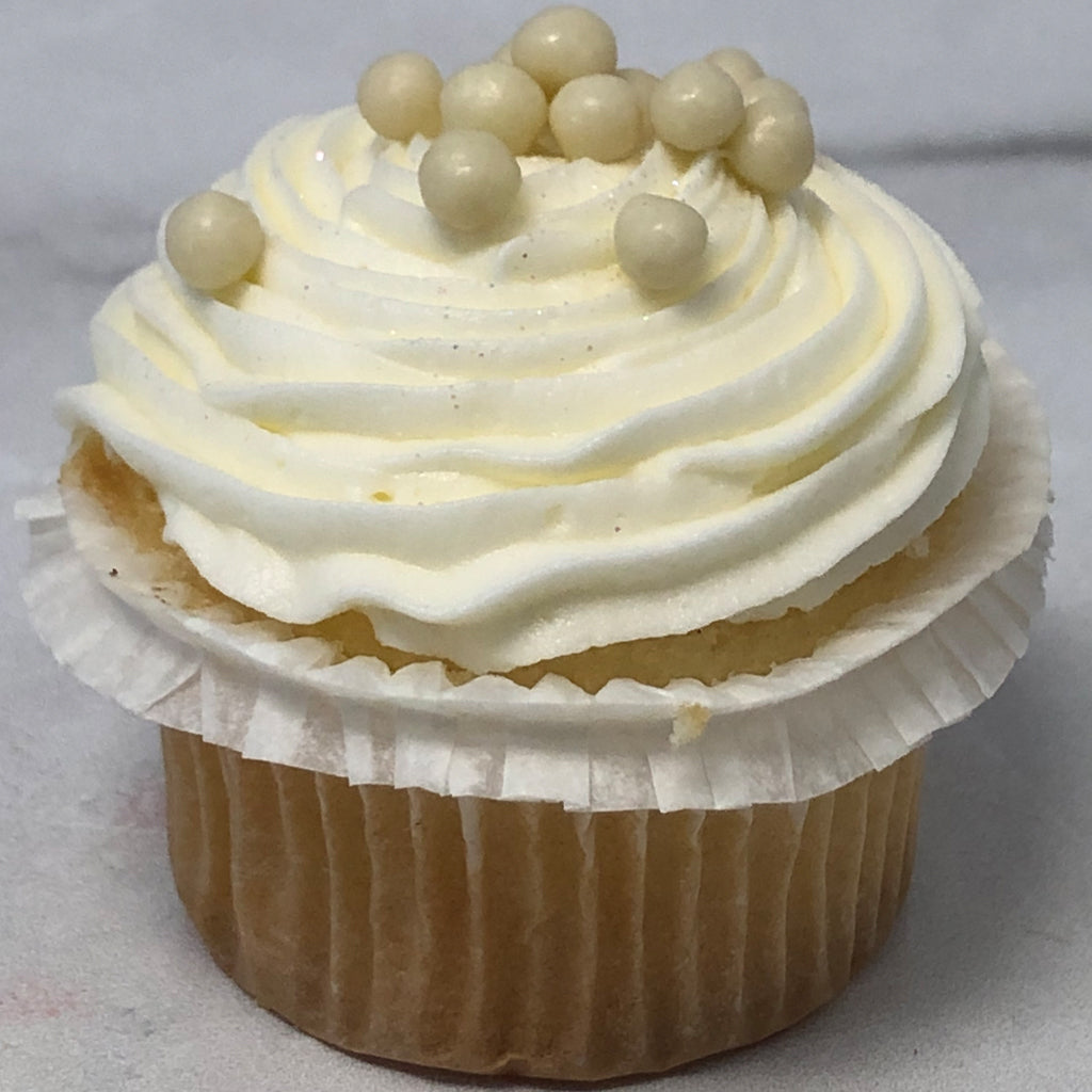 Mini vanilla cupcake with white frosting and pearl sprinkles