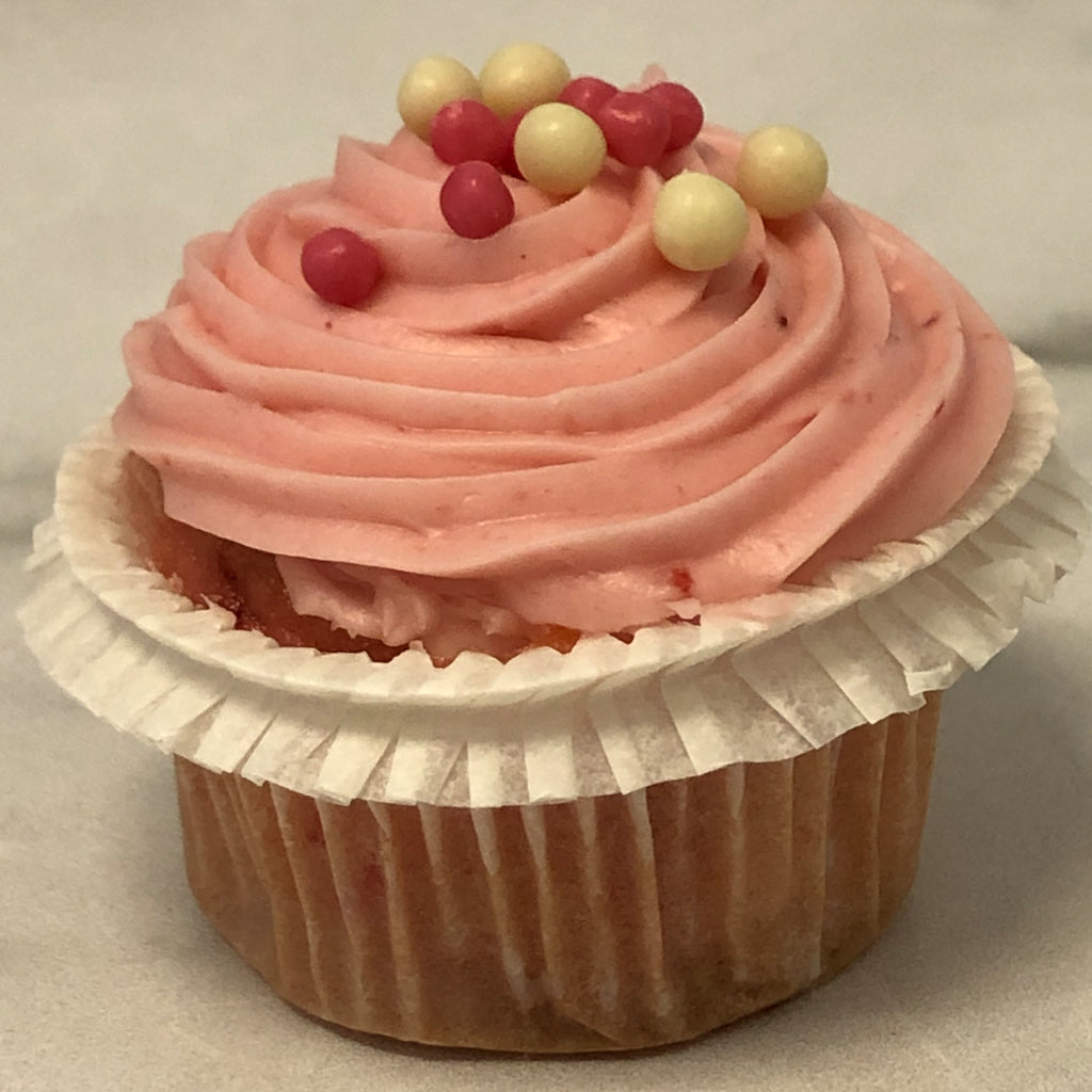 Mini strawberry cupcake with pink frosting and pearl sprinkles