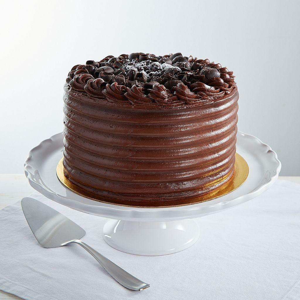 9-inch Mom's Chocolate Cake with ridged frosting on a stand.